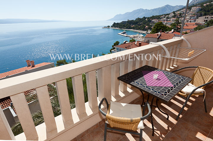 balcony with stone fence, panorama view on adriatic sea and Brela soline