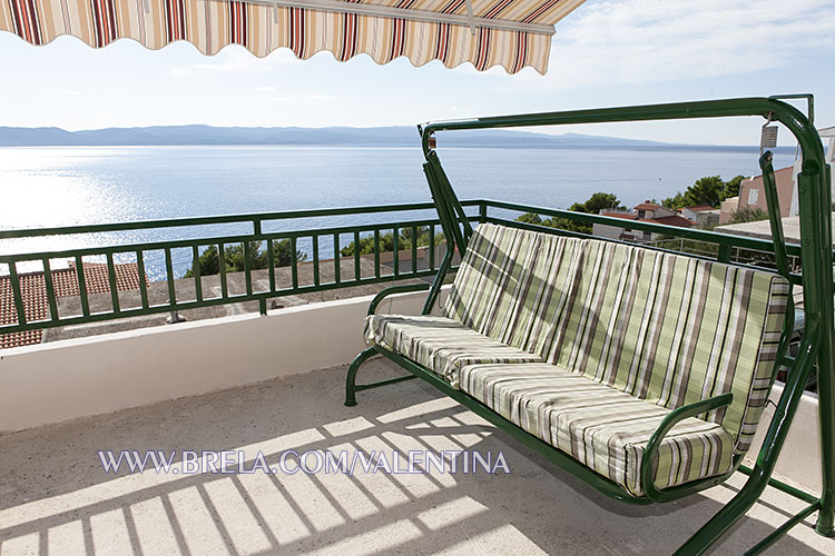 rocking chair, sofa with sea view from balcony